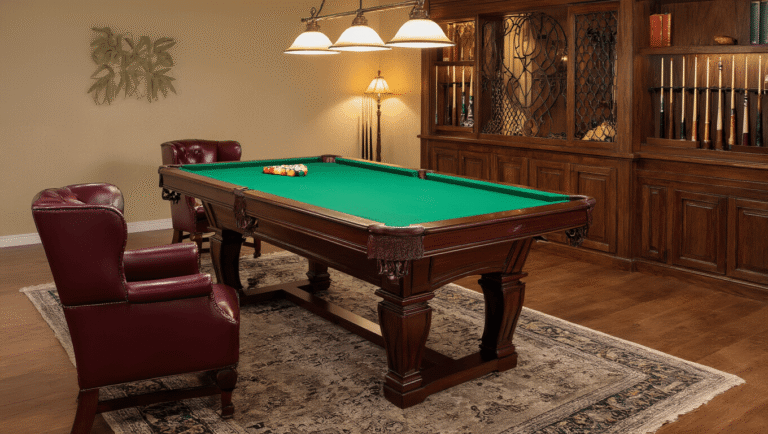 Elegant game room featuring an 8-foot mahogany pool table with emerald green felt, surrounded by burgundy leather chairs and warm golden lighting, highlighting polished hardwood floors and a stone accent wall.